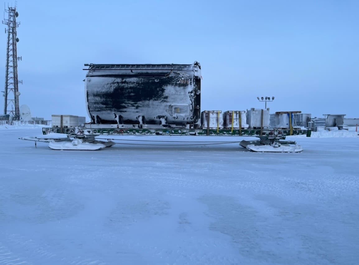 A large process tank secured on a Mammoth sled with supply tanks beside it.